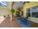 Inviting covered patio featuring an outdoor dining set and seating area for entertaining at 10306 Shalimar Wood Dr, Thonotosassa, FL 33592
