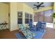 Covered patio with a lounge chair and seating area, providing a relaxing outdoor space at 10306 Shalimar Wood Dr, Thonotosassa, FL 33592