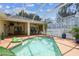 An amazing screened-in pool with patio furniture, potted plants, and room for entertaining Gathering and friends at 10306 Shalimar Wood Dr, Thonotosassa, FL 33592