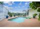 Lovely screened-in pool area featuring a sparkling pool, potted plants and space to relax at 10306 Shalimar Wood Dr, Thonotosassa, FL 33592