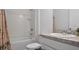 Clean bathroom featuring a shower-tub combo and a modern vanity with storage at 10448 Ladybug Cv, Parrish, FL 34219