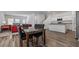 Open-concept dining area with dark wood table, adjacent to the kitchen and living room at 10448 Ladybug Cv, Parrish, FL 34219