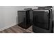 Laundry room featuring dark modern, front-load washing machine and dryer at 10448 Ladybug Cv, Parrish, FL 34219