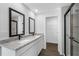 Stylish bathroom showcasing double sinks with granite countertops and a sleek glass-enclosed shower at 11199 Murraysville Dr, Spring Hill, FL 34609