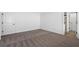 A carpeted bedroom with a clean and modern look featuring a neutral color palette and a view into the ensuite at 11199 Murraysville Dr, Spring Hill, FL 34609