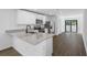 Open kitchen features granite countertops, stainless steel appliances, and access to the living room at 11199 Murraysville Dr, Spring Hill, FL 34609