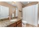 This bathroom offers a granite countertop, updated fixtures, and a shower with a curtain at 11206 Coventry Grove Cir, Lithia, FL 33547