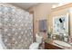 Cozy bathroom featuring granite counters, sink, toilet, and tiled shower with unique curtain at 11206 Coventry Grove Cir, Lithia, FL 33547