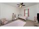 This bedroom offers natural light, a ceiling fan, and light pink accents at 11206 Coventry Grove Cir, Lithia, FL 33547