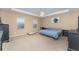 Large bedroom with a ceiling fan, carpet, two windows, and a blue comforter on the bed at 11206 Coventry Grove Cir, Lithia, FL 33547