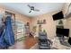 This bedroom features hardwood floors, a ceiling fan, and lots of natural light at 11206 Coventry Grove Cir, Lithia, FL 33547