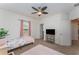 This bedroom provides neutral-colored carpet, a ceiling fan, and a window with curtains at 11206 Coventry Grove Cir, Lithia, FL 33547