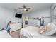 Spacious bedroom with a ceiling fan, TV, and a view to another room at 11206 Coventry Grove Cir, Lithia, FL 33547