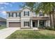 Charming two-story home with well-manicured lawn, covered porch with pillars and an attached two-car garage at 11206 Coventry Grove Cir, Lithia, FL 33547