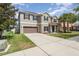 Two-story home with a spacious driveway leading to an attached two-car garage and a well-maintained front yard at 11206 Coventry Grove Cir, Lithia, FL 33547