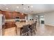 Open kitchen features granite countertops, stainless steel appliances, and a center island with bar seating at 11206 Coventry Grove Cir, Lithia, FL 33547