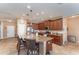 Modern kitchen with stainless steel appliances, granite countertops, a center island with bar seating, and ample cabinet space at 11206 Coventry Grove Cir, Lithia, FL 33547