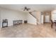 Open living area features tiled floor, ceiling fan, staircase, and flows into the kitchen and dining areas at 11206 Coventry Grove Cir, Lithia, FL 33547