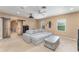 This living room offers a large sofa, a ceiling fan, and many windows for natural light at 11206 Coventry Grove Cir, Lithia, FL 33547
