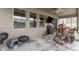 Covered patio with brick pavers, grill, table, chairs, ceiling fan, and TV at 11206 Coventry Grove Cir, Lithia, FL 33547