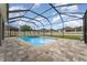 Backyard featuring a screened in pool, spa, brick patio, and fence at 11206 Coventry Grove Cir, Lithia, FL 33547