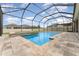Backyard with screened in pool, hot tub, brick paver patio, and a fence at 11206 Coventry Grove Cir, Lithia, FL 33547