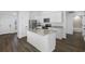 Modern kitchen featuring white cabinets, granite countertops, stainless steel appliances, and wood flooring at 11300 Libby Rd, Spring Hill, FL 34609