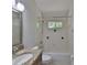 Bathroom featuring granite countertop, single sink, a large mirror and a bathtub at 11726 S Stone Ln, Riverview, FL 33569