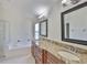 Bathroom featuring dual sinks, granite countertop, soaking tub, and glass enclosed shower at 11726 S Stone Ln, Riverview, FL 33569