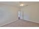 Bedroom featuring neutral walls, plush carpet, and view into the hallway at 11726 S Stone Ln, Riverview, FL 33569