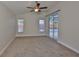 Bedroom featuring neutral walls, carpet, ceiling fan, and sliding glass doors to the pool area at 11726 S Stone Ln, Riverview, FL 33569
