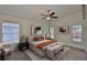 Spacious bedroom with neutral color palette, ceiling fan, natural light and decorative accent pieces at 11726 S Stone Ln, Riverview, FL 33569