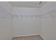Walk-in closet with multiple rows of shelving, providing plenty of storage space at 11726 S Stone Ln, Riverview, FL 33569