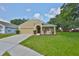 Charming single-Gathering home with a manicured lawn, inviting curb appeal, and an attached two-car garage at 11726 S Stone Ln, Riverview, FL 33569