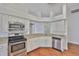 Bright kitchen features stainless steel appliances, granite countertops, and wooden floors at 11726 S Stone Ln, Riverview, FL 33569