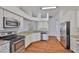 Bright kitchen features stainless steel appliances, granite countertops, and wooden floors at 11726 S Stone Ln, Riverview, FL 33569