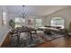 Open-concept living room with a formal dining setup and a comfortable sitting area bathed in natural light at 11726 S Stone Ln, Riverview, FL 33569
