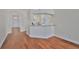 View of the living room and kitchen, showcasing the open layout and hardwood floors at 11726 S Stone Ln, Riverview, FL 33569
