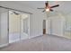 Large main bedroom with ceiling fan, carpeted floors, and adjacent sitting room or bathroom at 11726 S Stone Ln, Riverview, FL 33569