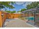 An enclosed backyard area features a screened-in pool, and a rock landscape for low-maintenance care at 11726 S Stone Ln, Riverview, FL 33569