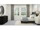 Bright bedroom featuring a dark wood dresser, plush bed, and a serene view from the window at 11733 E 71St Ter, Palmetto, FL 34221
