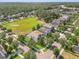 Aerial view of a residential neighborhood featuring tree-lined streets, a park, and well-maintained homes at 11802 Twilight Darner Pl, Riverview, FL 33569