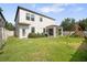Spacious backyard with a well-maintained lawn, partial fence, covered patio, and a swing set at 11802 Twilight Darner Pl, Riverview, FL 33569