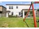 View of backyard with covered patio furniture, grill, lush green grass, and fenced yard at 11802 Twilight Darner Pl, Riverview, FL 33569