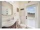 Bright bathroom featuring a decorative mirror, beadboard paneling, and an exterior door for convenient access at 11802 Twilight Darner Pl, Riverview, FL 33569