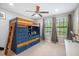 Bedroom featuring a unique loft bed with built-in storage and a sunny window at 11802 Twilight Darner Pl, Riverview, FL 33569