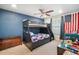 Bright bedroom featuring a bunk bed with a slide and an American flag tapestry on the wall at 11802 Twilight Darner Pl, Riverview, FL 33569