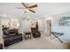 Open bonus room with neutral carpet, leather seating, and additional flexible space at 11802 Twilight Darner Pl, Riverview, FL 33569