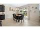 Bright dining room featuring an elegant chandelier and sliding doors to the outdoor patio at 11802 Twilight Darner Pl, Riverview, FL 33569