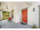 Charming front porch with a vibrant red door, cozy seating, and welcoming decor at 11802 Twilight Darner Pl, Riverview, FL 33569
